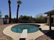 A serene backyard featuring a diving board and an enticing oval shaped pool with a concrete patio at 2834 E Juanita Ave, Mesa, AZ 85204