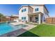 Spacious backyard with a pool, patio, outdoor seating, and artificial grass at 29051 N Shannon Dr, San Tan Valley, AZ 85143