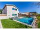 Stunning backyard featuring a pool, spa, outdoor kitchen, and lush landscaping at 29051 N Shannon Dr, San Tan Valley, AZ 85143