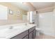 Bathroom with double sink vanity and shower with tub, providing convenience and comfort at 29051 N Shannon Dr, San Tan Valley, AZ 85143
