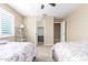 Bedroom featuring two beds, neutral walls, carpet, and a ceiling fan, creating a cozy vibe at 29051 N Shannon Dr, San Tan Valley, AZ 85143
