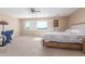Spacious bedroom showcasing a ceiling fan, large window with shutter and neutral tones at 29051 N Shannon Dr, San Tan Valley, AZ 85143