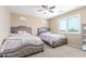 Bedroom featuring two beds, neutral walls, carpet, and a ceiling fan, creating a cozy vibe at 29051 N Shannon Dr, San Tan Valley, AZ 85143