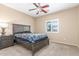 Comfortable bedroom with a ceiling fan, a large window with shutters and a night stand at 29051 N Shannon Dr, San Tan Valley, AZ 85143