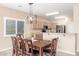 Charming dining area with modern lighting fixture and views of the outdoor landscape at 29051 N Shannon Dr, San Tan Valley, AZ 85143