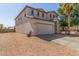 Two-story home with a two-car garage, desert landscaping, and an arched entryway at 29051 N Shannon Dr, San Tan Valley, AZ 85143