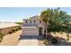 Beautiful two-story home with a desert landscaped front yard, mature trees, and a two-car garage at 29051 N Shannon Dr, San Tan Valley, AZ 85143