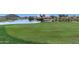 A serene golf course with lush green grass and a pristine lake. Perfect for leisurely recreation within the community at 29051 N Shannon Dr, San Tan Valley, AZ 85143