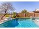 Beautiful pool with a waterfall feature, lush landscaping, and a view of the backyard at 29051 N Shannon Dr, San Tan Valley, AZ 85143