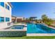 Resort-style backyard with a sparkling pool, spa, and covered outdoor kitchen at 29051 N Shannon Dr, San Tan Valley, AZ 85143