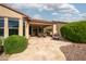 Back patio with travertine tile, an outdoor kitchen, and a seating area at 29624 N 128Th Ln, Peoria, AZ 85383