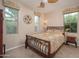 Inviting bedroom with decorative window treatments, fan and a stylish metal bed frame at 29624 N 128Th Ln, Peoria, AZ 85383