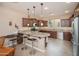 Well-equipped kitchen with granite countertops, dark wood cabinetry, and stainless steel appliances at 29624 N 128Th Ln, Peoria, AZ 85383