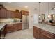 Spacious kitchen featuring stainless steel appliances, granite countertops, and custom wood cabinets at 29624 N 128Th Ln, Peoria, AZ 85383