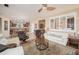 Open-concept living room with tile flooring, comfortable seating, and a ceiling fan at 29624 N 128Th Ln, Peoria, AZ 85383