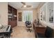 Home office with built-in shelving, plantation shutters, and a ceiling fan at 29624 N 128Th Ln, Peoria, AZ 85383