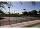 Well-maintained tennis court surrounded by lush greenery for recreational enjoyment and outdoor activities at 29624 N 128Th Ln, Peoria, AZ 85383