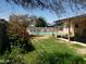 Private backyard with a refreshing swimming pool, lush greenery, and relaxing patio area at 3141 W Joan De Arc Ave, Phoenix, AZ 85029
