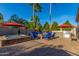 Backyard featuring a hot tub, fire pit, BBQ area, and ample seating under colorful umbrellas at 3150 E Isaiah Ave, Gilbert, AZ 85298