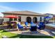 Spacious backyard featuring a fire pit, outdoor kitchen, and lush lawn for recreation at 3150 E Isaiah Ave, Gilbert, AZ 85298