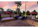Backyard oasis with hot tub, fire pit, built-in grill, and mature landscaping at 3150 E Isaiah Ave, Gilbert, AZ 85298