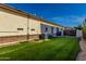 Backyard featuring artificial turf, gravel, and a view of the exterior of the house at 3150 E Isaiah Ave, Gilbert, AZ 85298