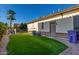 The landscaped backyard offers lush artificial turf and a convenient side entry door at 3150 E Isaiah Ave, Gilbert, AZ 85298