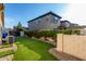 A beautiful and well-manicured backyard with artificial turf and beautiful flowering vines at 3150 E Isaiah Ave, Gilbert, AZ 85298