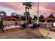Backyard oasis with hot tub, fire pit, built-in grill, and mature landscaping at 3150 E Isaiah Ave, Gilbert, AZ 85298