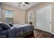 A comfortable bedroom with a ceiling fan, window, and sliding door closet at 3150 E Isaiah Ave, Gilbert, AZ 85298