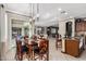 Open concept with dining area, tiled floors, elegant lighting, and seamless connection to kitchen at 3150 E Isaiah Ave, Gilbert, AZ 85298