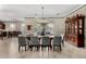 Inviting dining area featuring a large window with backyard views, a wooden hutch, and an elegant chandelier at 3150 E Isaiah Ave, Gilbert, AZ 85298