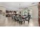Open-concept dining room with tiled floors, a large table, and seamless flow to outdoor living area at 3150 E Isaiah Ave, Gilbert, AZ 85298