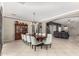 Elegant dining room features a large wooden table, chandelier, and hutch, offering ample space for entertaining guests at 3150 E Isaiah Ave, Gilbert, AZ 85298