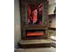 Living area showcasing a unique stone fireplace with vibrant, glowing embers and striking art at 3150 E Isaiah Ave, Gilbert, AZ 85298