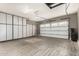 Spacious garage with epoxy flooring, custom cabinets, and a door leading to the outside at 3150 E Isaiah Ave, Gilbert, AZ 85298