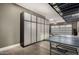 Well-organized garage features custom cabinets and a ping pong table for Gathering fun at 3150 E Isaiah Ave, Gilbert, AZ 85298