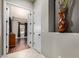 Inviting hallway showcasing modern decor leading to a bedroom with wood flooring and natural light at 3150 E Isaiah Ave, Gilbert, AZ 85298