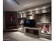 Modern living room featuring a stone fireplace, display shelving, and a sleek entertainment center at 3150 E Isaiah Ave, Gilbert, AZ 85298