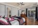 This main bedroom features wood floors, ceiling fan, and glass patio doors at 3150 E Isaiah Ave, Gilbert, AZ 85298