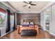 The main bedroom boasts a wood accent wall, tray ceilings and light-filled windows at 3150 E Isaiah Ave, Gilbert, AZ 85298