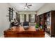 Home office featuring a wooden desk, built-in bookshelves, and natural light at 3150 E Isaiah Ave, Gilbert, AZ 85298
