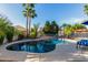 Inviting pool area with a volleyball net, basketball hoop, and clear blue water at 3150 E Isaiah Ave, Gilbert, AZ 85298