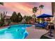 Spectacular backyard with a sparkling pool, lounge chairs, and mature landscaping at 3150 E Isaiah Ave, Gilbert, AZ 85298
