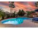Gorgeous backyard with a sparkling pool, volleyball net, hot tub, and cozy lounge area at 3150 E Isaiah Ave, Gilbert, AZ 85298