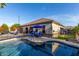Backyard pool with volleyball net and plenty of seating areas for relaxation and entertaining at 3150 E Isaiah Ave, Gilbert, AZ 85298