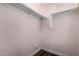 A walk-in closet features rod hangers and custom shelving for efficient storage solutions at 3150 E Isaiah Ave, Gilbert, AZ 85298