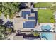 A bird's eye view of a home featuring a pool, solar panels, and a well-manicured lawn at 3252 E Lexington Ave, Gilbert, AZ 85234