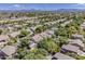 Expansive aerial view of a neighborhood with pools, green spaces, and mountain views at 3252 E Lexington Ave, Gilbert, AZ 85234