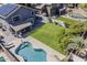 Aerial view of the house, showing the covered patio, well-manicured lawn, and sparkling swimming pool at 3252 E Lexington Ave, Gilbert, AZ 85234